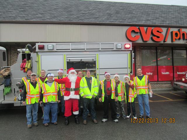 Harmon Engine Members & Fire Patrol Members Took  A Picture With Santa In Front Of Engine 120 By CVS During The 2013 Candy Cane Run 