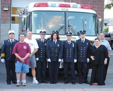 Members of Harmon Engine in front of Engine 120 at the 2011 Department Inspection .