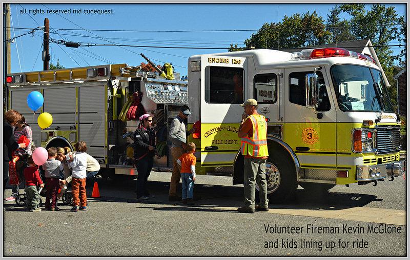 Firefighter Keven McColne Helping To Put Kids On Engine 120 Photo By Maria Cudequest 